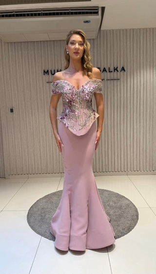 Woman in a pink, embellished, off-the-shoulder gown.