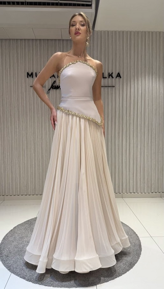 Woman in a formal cream dress.