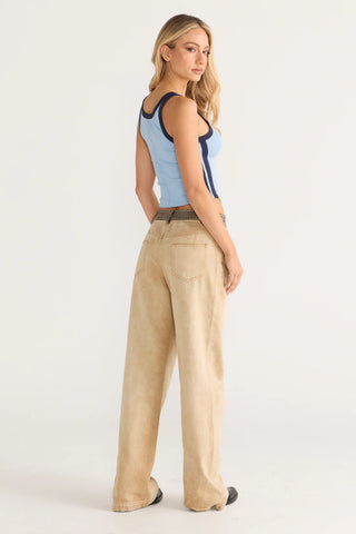 Woman in blue scoop neck tank and tan pants