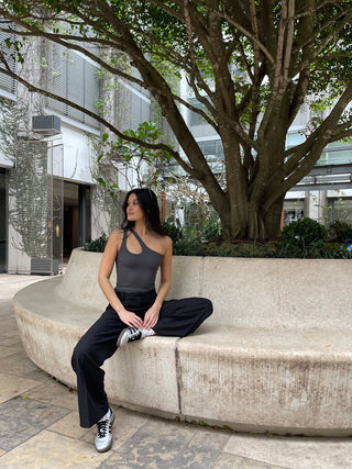 Woman in black tailored straight pants