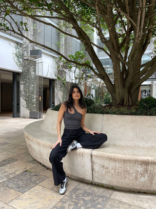 Woman in black tailored straight pants