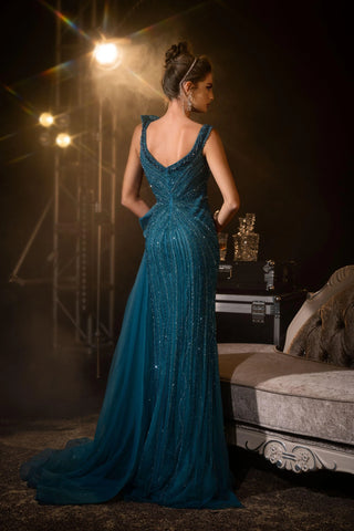 Woman in teal beaded gown.
