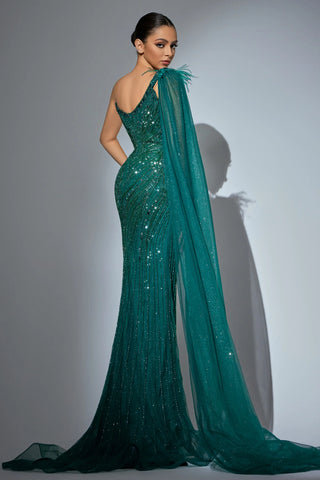 Woman in a teal one-shoulder gown with feathered detail and train.
