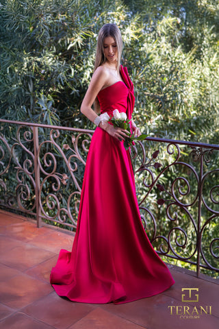 Woman in red gown holding flowers