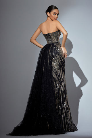 Woman in a strapless black and gold gown.