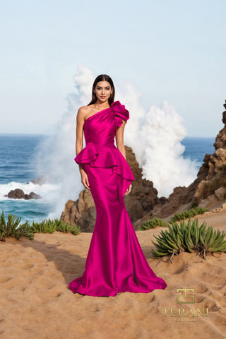 Fuchsia one-shoulder gown on woman by the sea