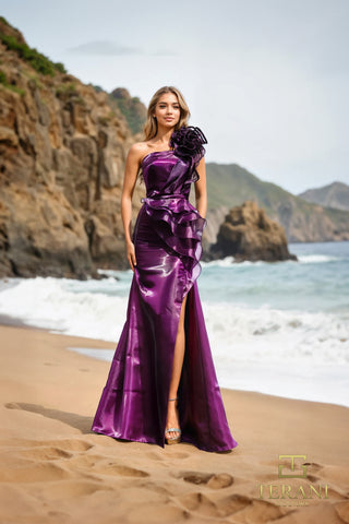 Plum formal gown with black floral accent by the beach.