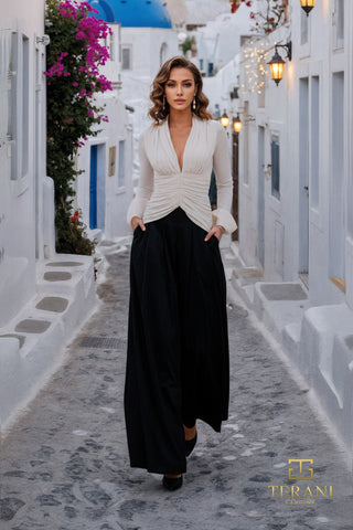 Woman in white top and black pants walking on Santorini street (261E6718A)