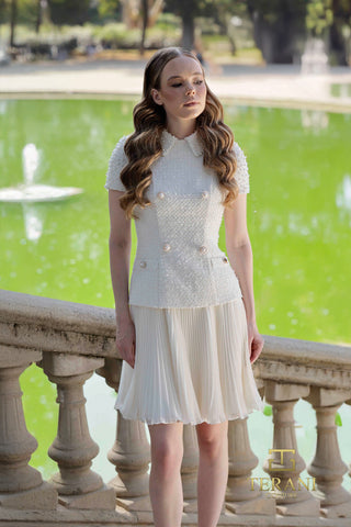 Woman in white dress by a pond.