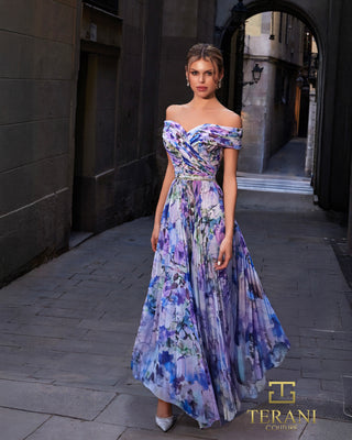 Woman in floral off-the-shoulder gown standing in a stone alley.
