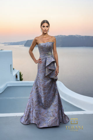 Blue and gold formal dress on woman overlooking sea