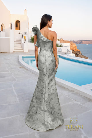 Silver one-shoulder gown by the pool.