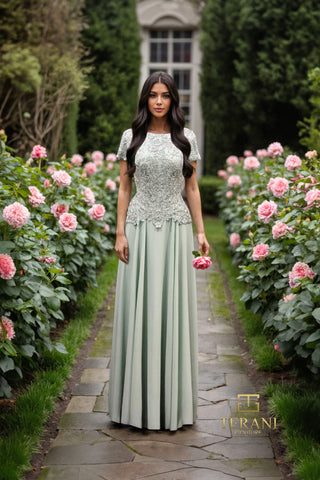 Woman in sage green gown in garden