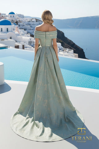 Sage green off-shoulder gown overlooking Santorini.