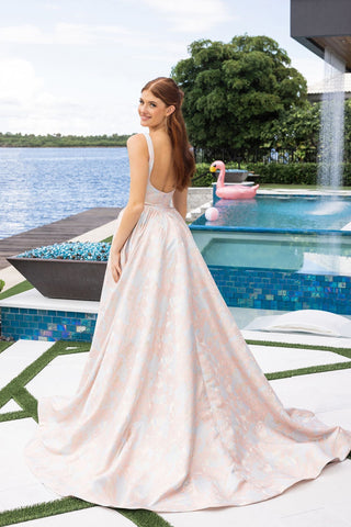 Elegant woman in pink formal gown by pool