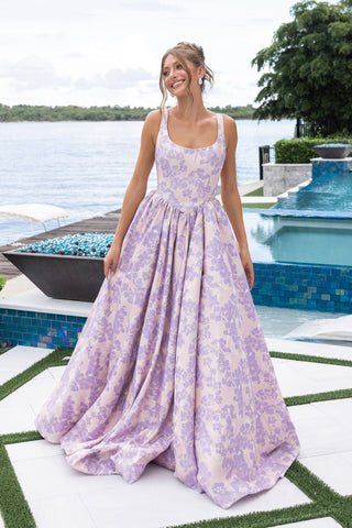 Woman in floral prom dress by pool
