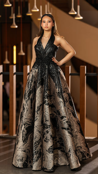 Woman in black and gold formal gown.