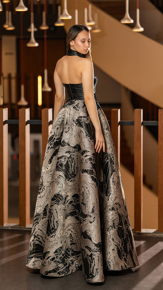 Woman in a formal gown, looking over her shoulder.