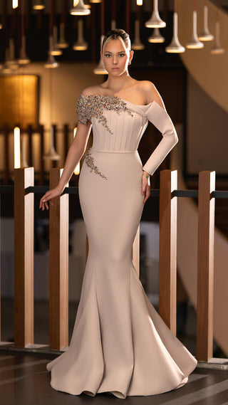 Woman in a formal, one-shoulder gown.