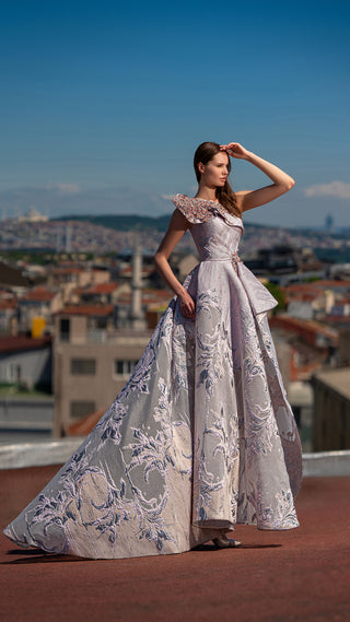 Woman in formal gown outdoors.