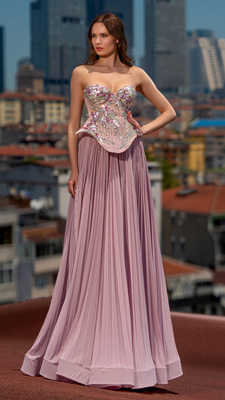 Woman in formal gown, city backdrop.