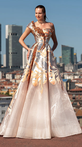 Woman in a gold and silver patterned gown.