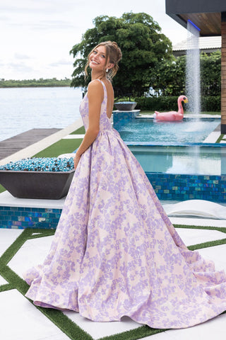 Woman in floral gown by pool