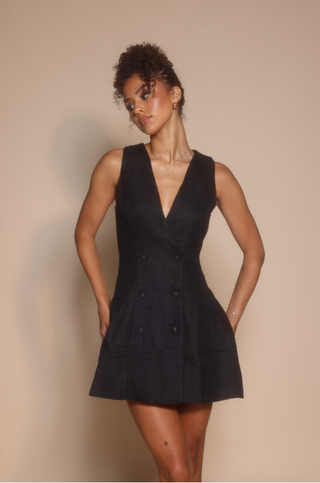 Woman in black dress, screenshot Oct 30, 2025