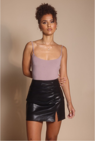 Woman in leather skirt, screenshot Oct 30, 2025