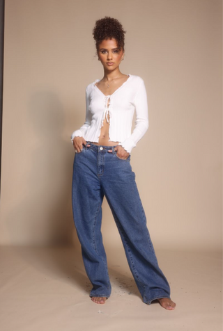 Woman in white top and jeans, screenshot from Oct 30, 2025