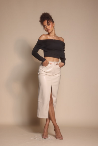 Woman in black top and cream skirt, Oct 30, 2025 screenshot.