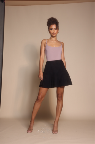 Woman in black skirt and top, screenshot from Oct 30, 2025.