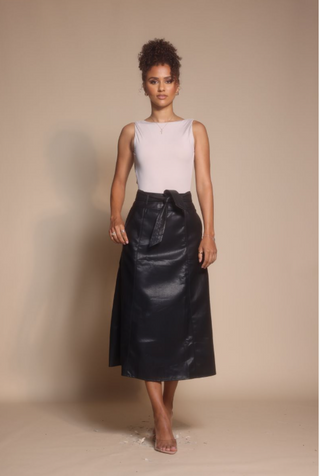 Woman in black leather skirt, screenshot from Oct 30, 2025