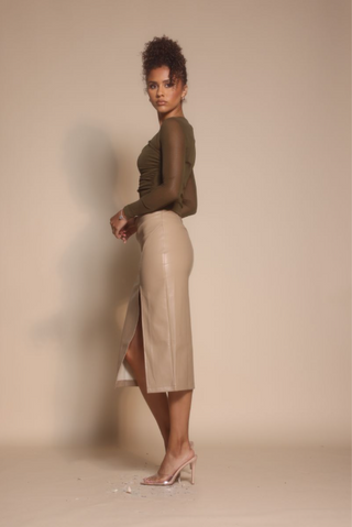 Woman in green top and leather skirt, Oct 30, 2025 screenshot.