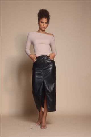 Woman in leather skirt and top, screenshot from Oct 30, 2025.