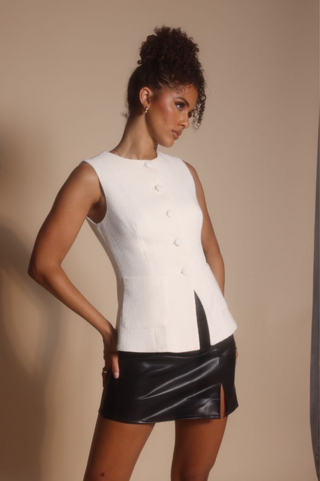 Woman in white top and black skirt, Oct 30, 2025 screenshot