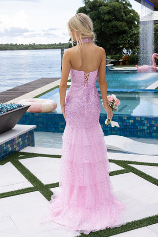Woman in pink formal dress by pool