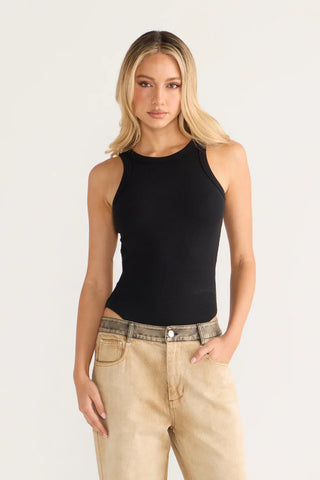 Chloe wearing black tank top and jeans