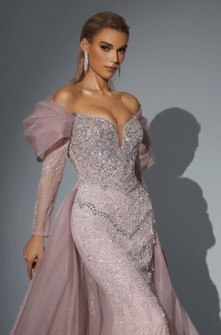 Woman in a sparkly, off-shoulder formal gown.