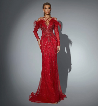 Woman in a red beaded evening gown with feathers.