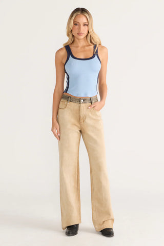 Woman in blue scoop neck top and tan jeans
